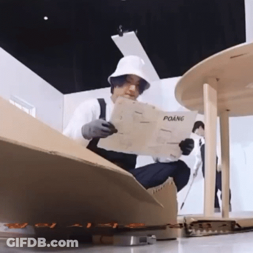 Man In White Hat Reading Newspaper Titled Poang GIF