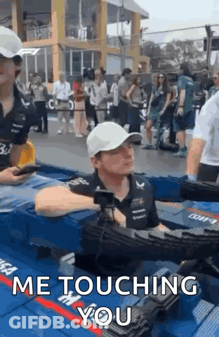 Man In White Hat Sitting In Pool Talking To Another Man GIF
