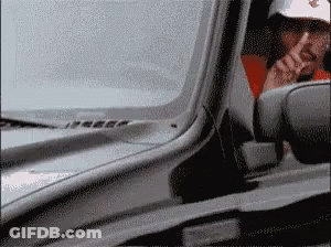Man In White Hat Smoking While Driving GIF