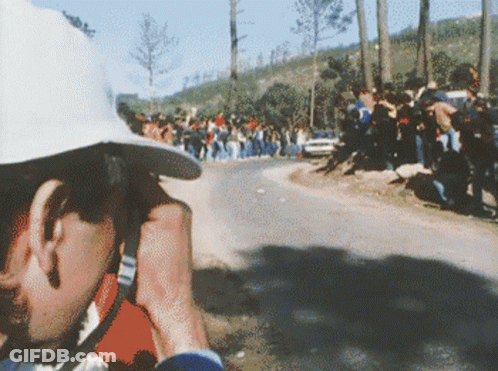 Man In White Hat Taking Photo Of Race GIF