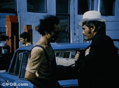 Man In White Hat Talking To Man In Overalls GIF
