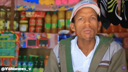 Man In White Hat With Red X And Bottle Display GIF