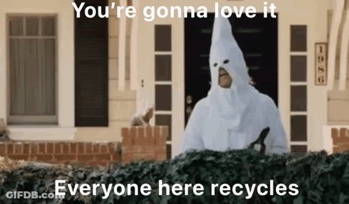 Man In White Hooded Costume In Front Of House GIF
