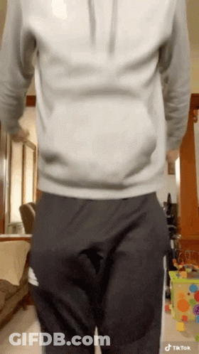 Man In White Hoodie And Black Pants With Hands In Pockets GIF