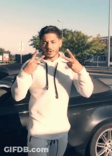 Man In White Hoodie In Front Of Black Car GIF