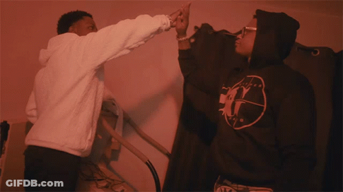 Man In White Hoodie Reaching To Black Hoodie Letter G GIF