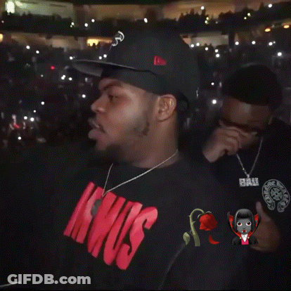 Man In White Hoodie Standing Before Crowd GIF