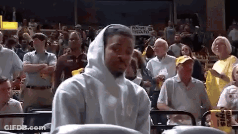 Man In White Hoodie Watching Basketball Game In Crowd GIF