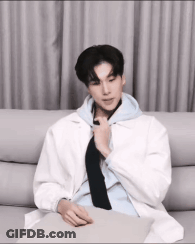 Man In White Jacket And Black Tie On Couch GIF