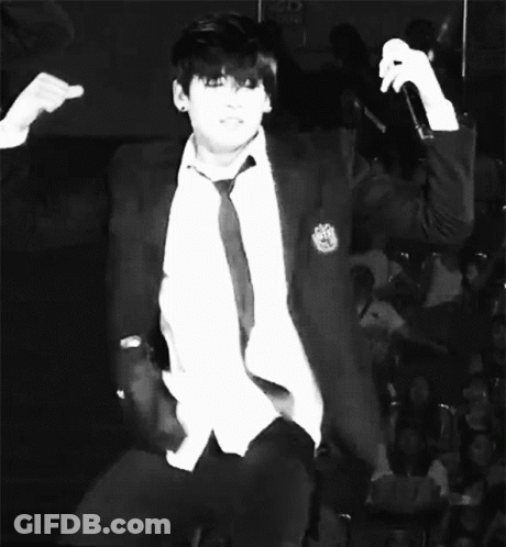 Man In White Jacket, Black Shirt, Purple Wall GIF