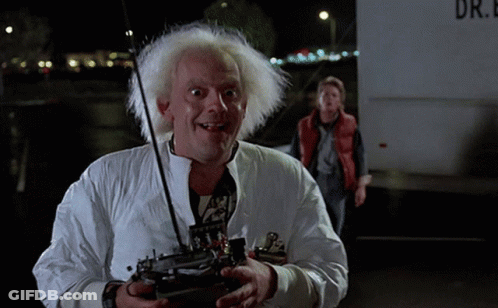 Man In White Jacket Holding Remote In Front Of Truck Saying Dr GIF