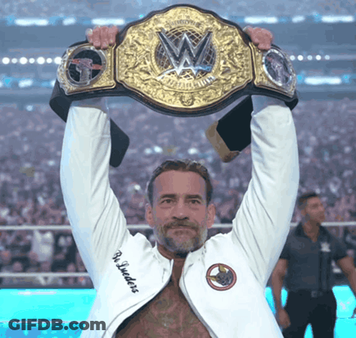 Man In White Jacket Holding Wrestling Championship Belt GIF