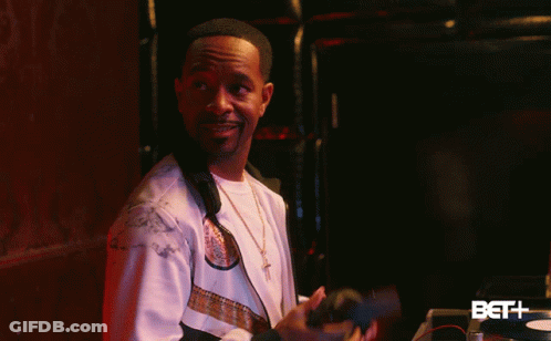 Man In White Jacket In Front Of BET Logo GIF