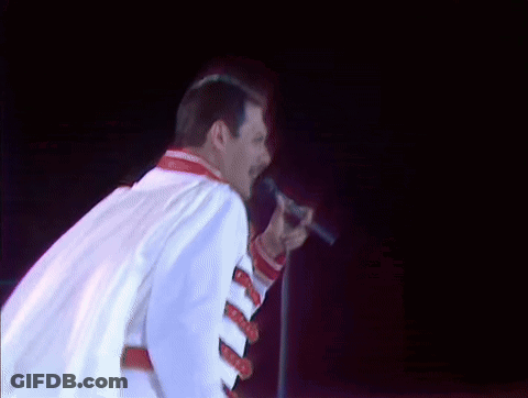 Man In White Jacket Singing Into Microphone GIF
