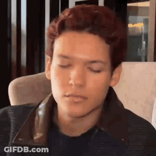 Man In White Jacket Walking Past ESET Wall GIF