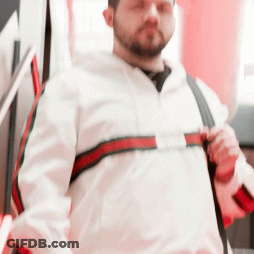 Man In White Jacket With Red And Green Striped Sleeves GIF