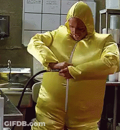 Man In White Jumpsuit In Hallway GIF