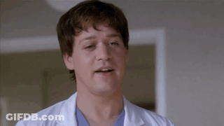 Man In White Lab Coat And Blue Scrub Making Funny Face GIF