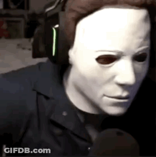 Man In White Mask Talking Into Microphone GIF