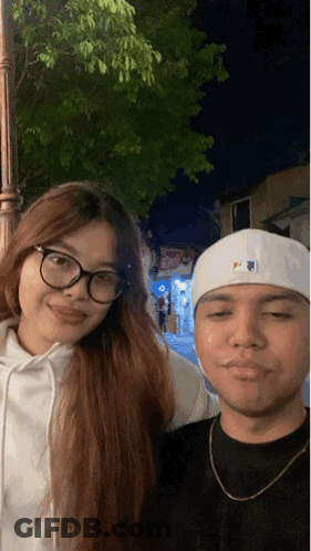Man In White MLB Hat Posing With Woman GIF