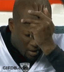 Man In White NFL Jersey Covering Face GIF