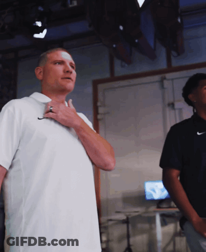 Man In White Nike Shirt Adjusting Tie GIF