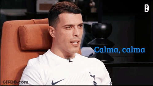 Man In White Nike Shirt Sitting In Orange Chair GIF
