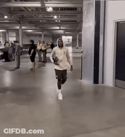 Man In White Nike Sweatshirt Running In Hallway GIF