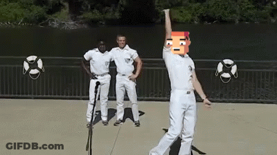 Man In White Pants Dancing At Microphone With Two Men Behind GIF