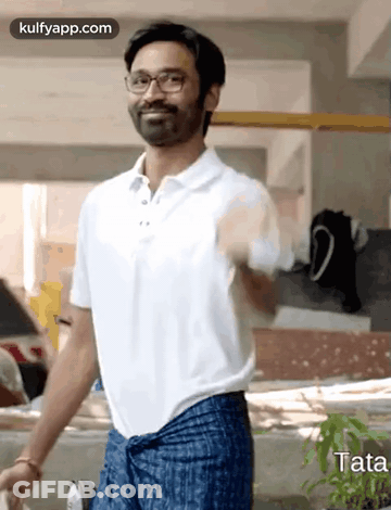 Man In White Polo And Blue Pants Standing In Front Of Building GIF
