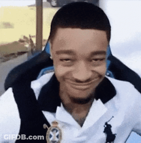 Man In White Polo Shirt Sitting In Chair Making Funny Face GIF