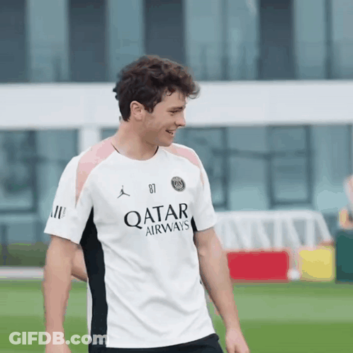 Man In White Qatar Airways Shirt Smiles GIF