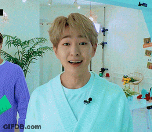 Man In White Robe And Microphone Smiling GIF