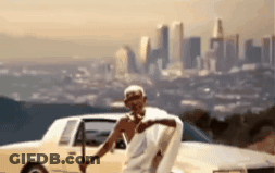 Man In White Robe By Car With City Background GIF