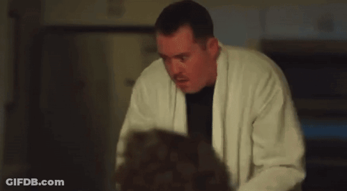 Man In White Robe Holding Gun GIF