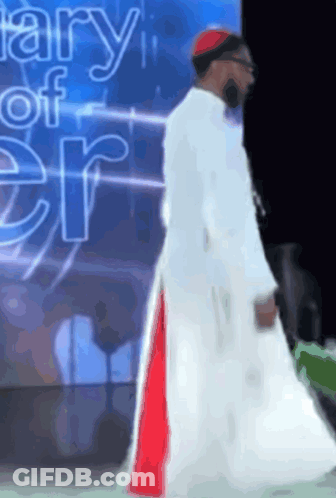 Man In White Robe In Front Of Diary Of Er Sign GIF