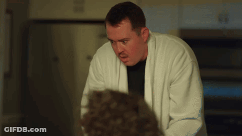 Man In White Robe Looking At Man In Black Shirt GIF