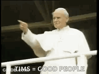 Man In White Robe Pointing From Balcony GIF