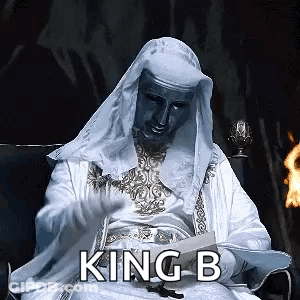 Man In White Robe Reading Book With King B GIF