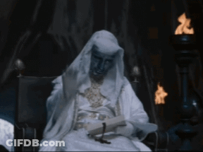 Man In White Robe Sitting In Chair GIF