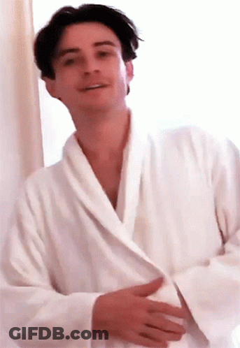 Man In White Robe Smiling At Camera GIF