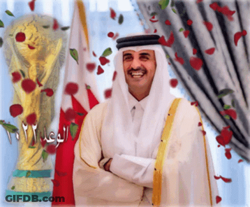 Man In White Robe Smiling At Trophy 2012 GIF