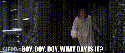 Man In White Robe Standing In Dark Room Talking GIF