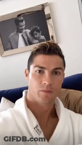 Man In White Robe Taking Selfie By Picture GIF