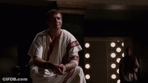 Man In White Robe With Red Stripe On Sleeves GIF