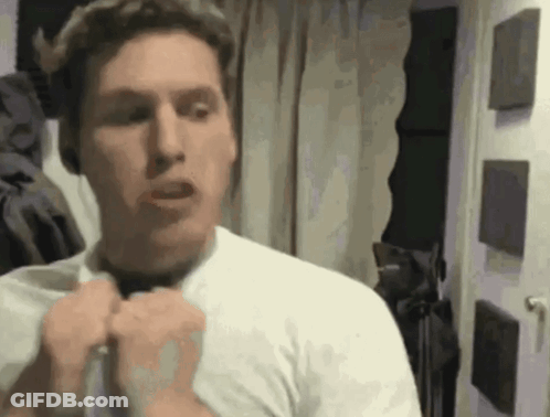 Man In White Shirt Adjusting Shirt In Mirror GIF