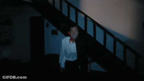 Man In White Shirt And Black Cape Walking Down Stairs GIF