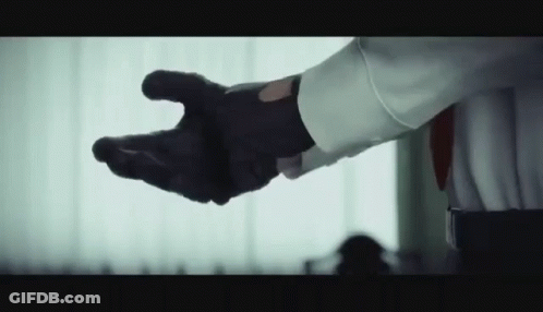 Man In White Shirt And Black Gloves Reaching GIF
