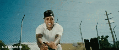 Man In White Shirt And Black Hat By Chain Link Fence GIF