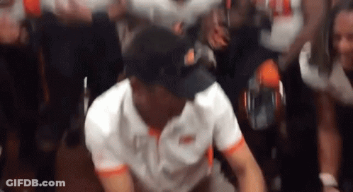Man In White Shirt And Black Hat Dancing In Front Of Crowd GIF